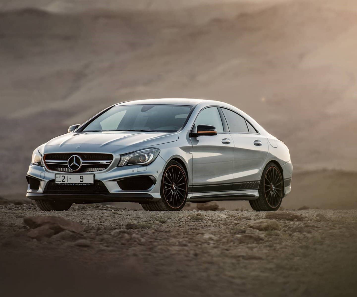 Silver Mercedes coupé in the desert at dusk