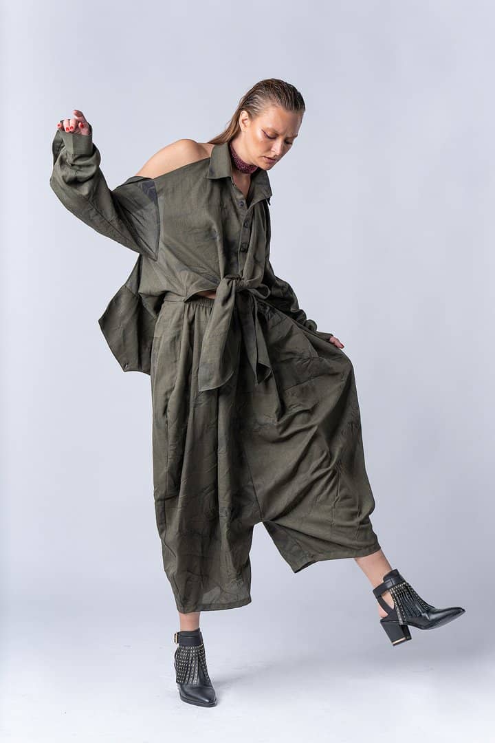 Model in an olive utility set on white