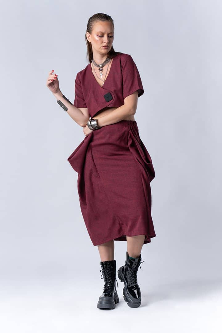Model in a burgundy dress on white