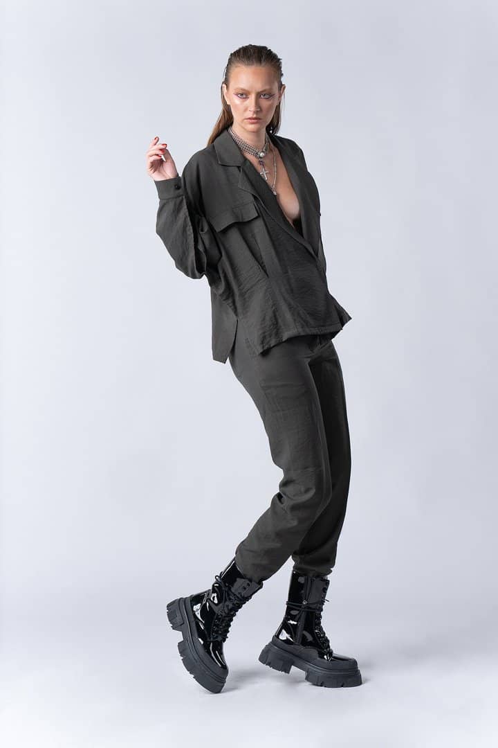 Model in charcoal separates on white