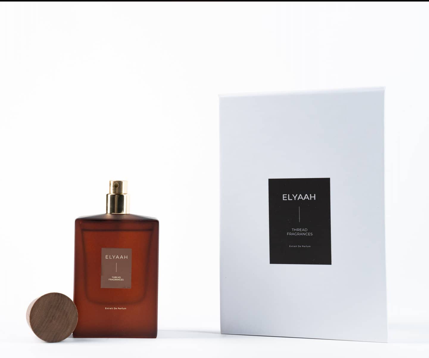 Amber perfume with its gift box on white