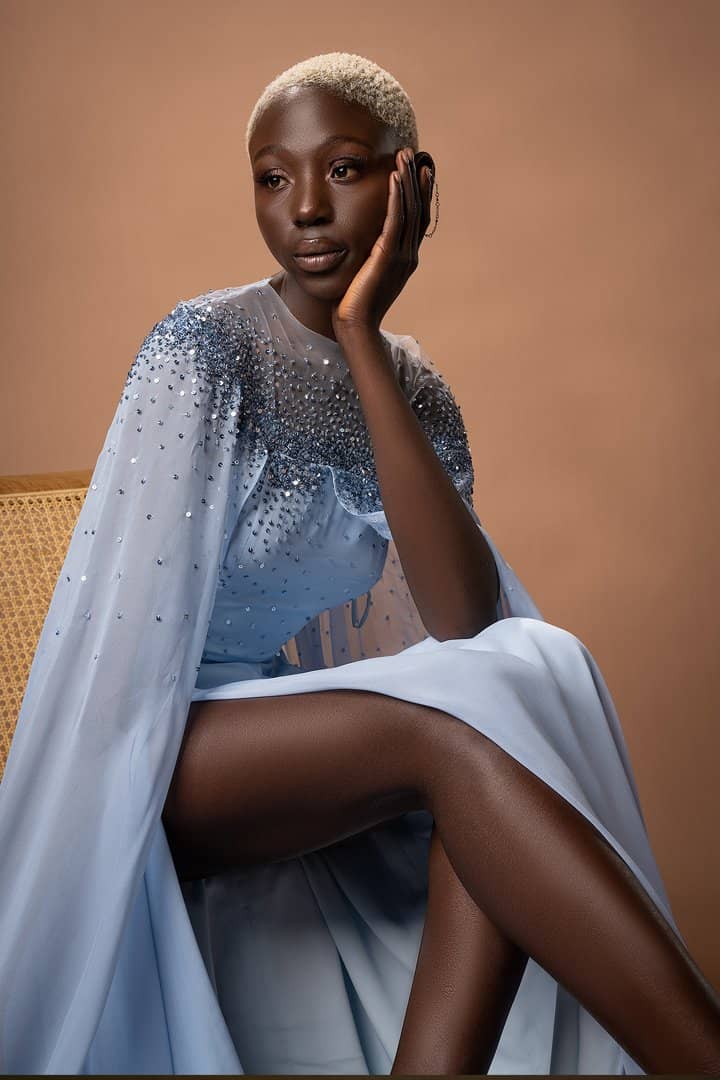Model in an embellished pale-blue gown, seated