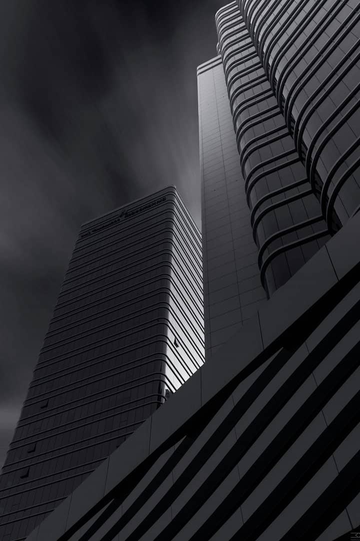 Looking up at a tower in black and white