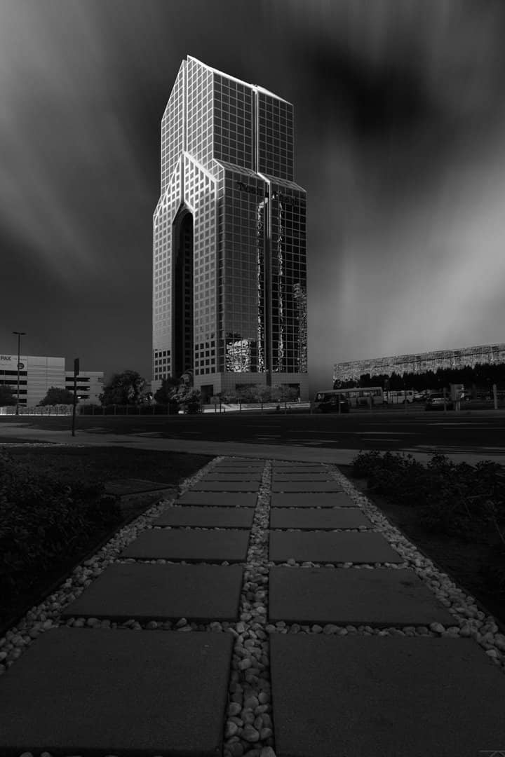 Tower at the end of a long path in black and white