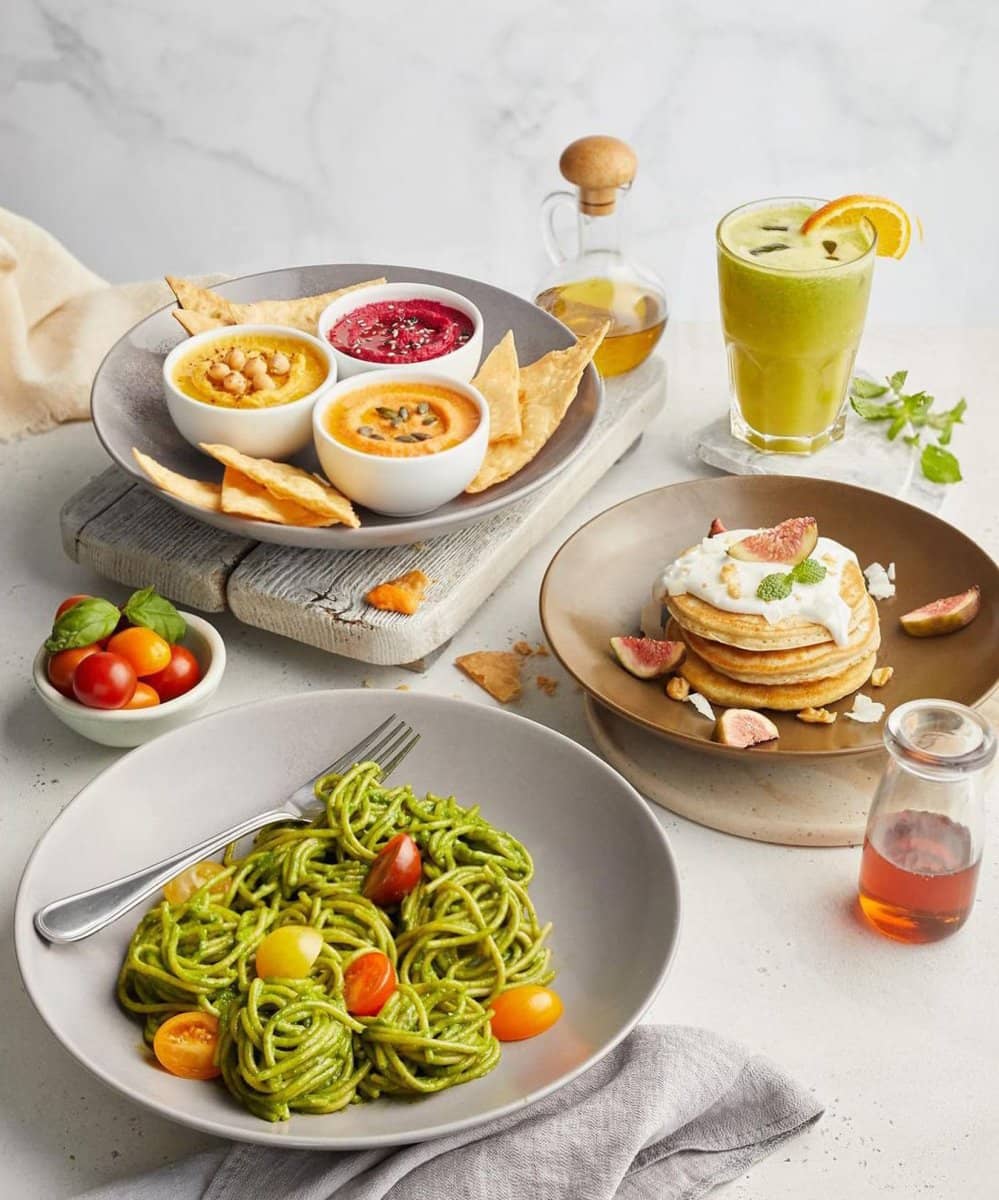 Brunch spread with pancakes and pesto pasta