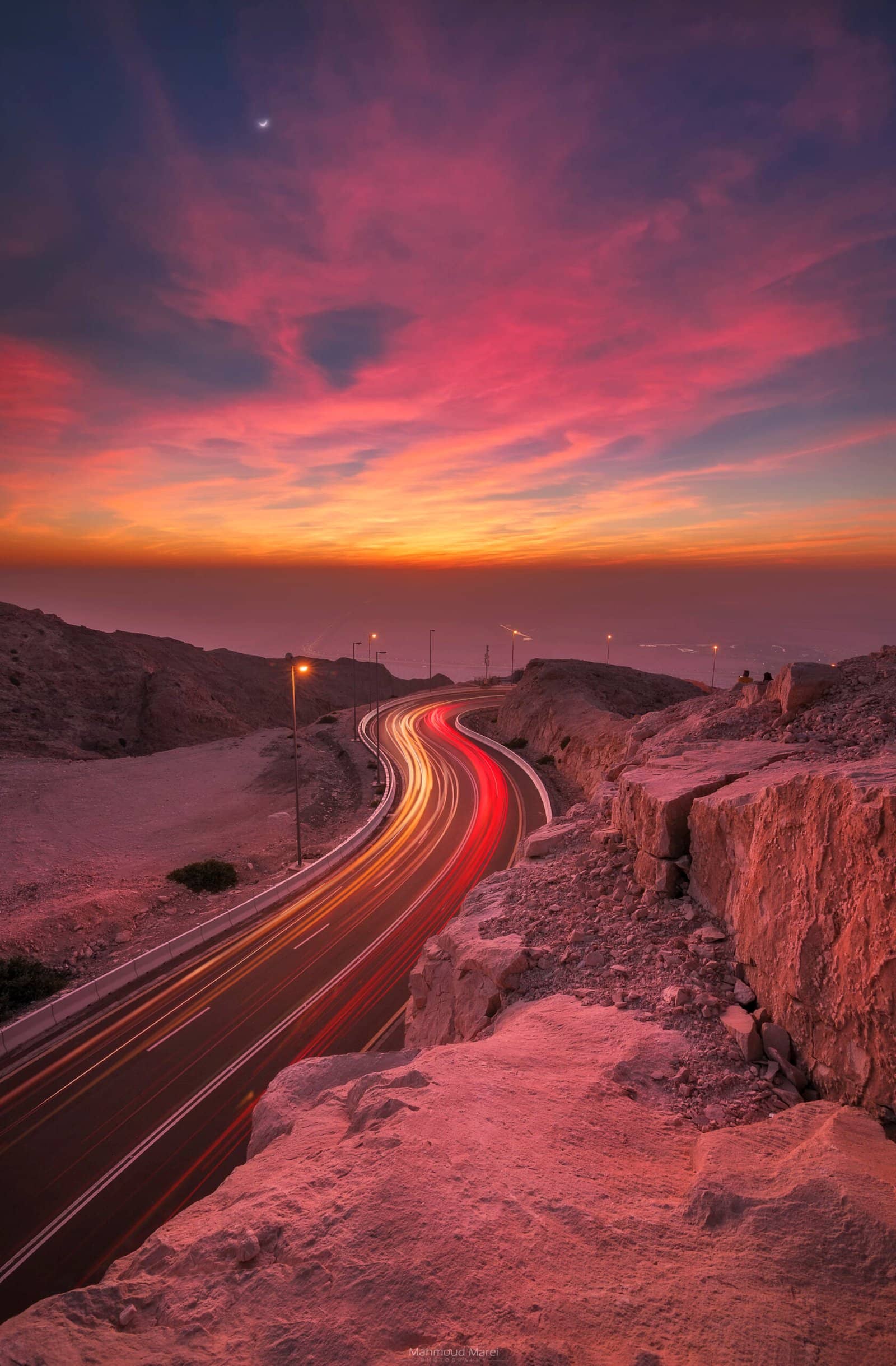 Light trails winding up Jebel Hafeet at dusk