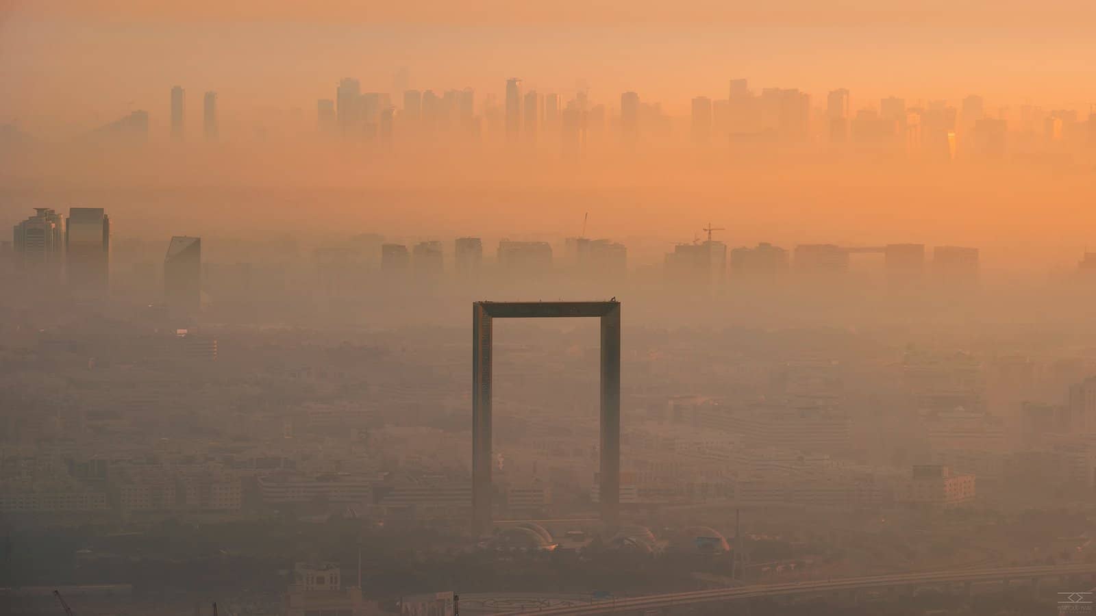 The Dubai Frame emerging from morning fog