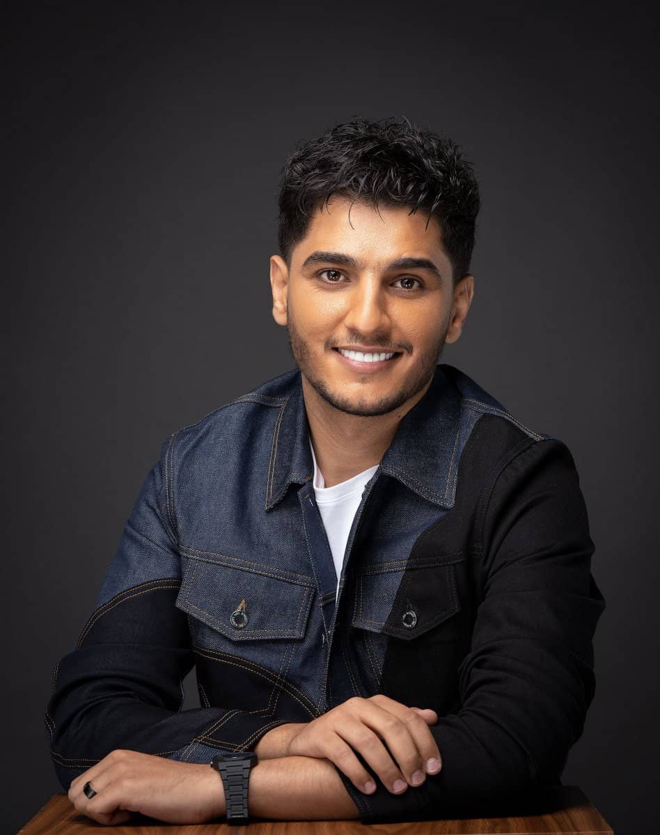 Mohammad Assaf in a denim jacket, studio portrait