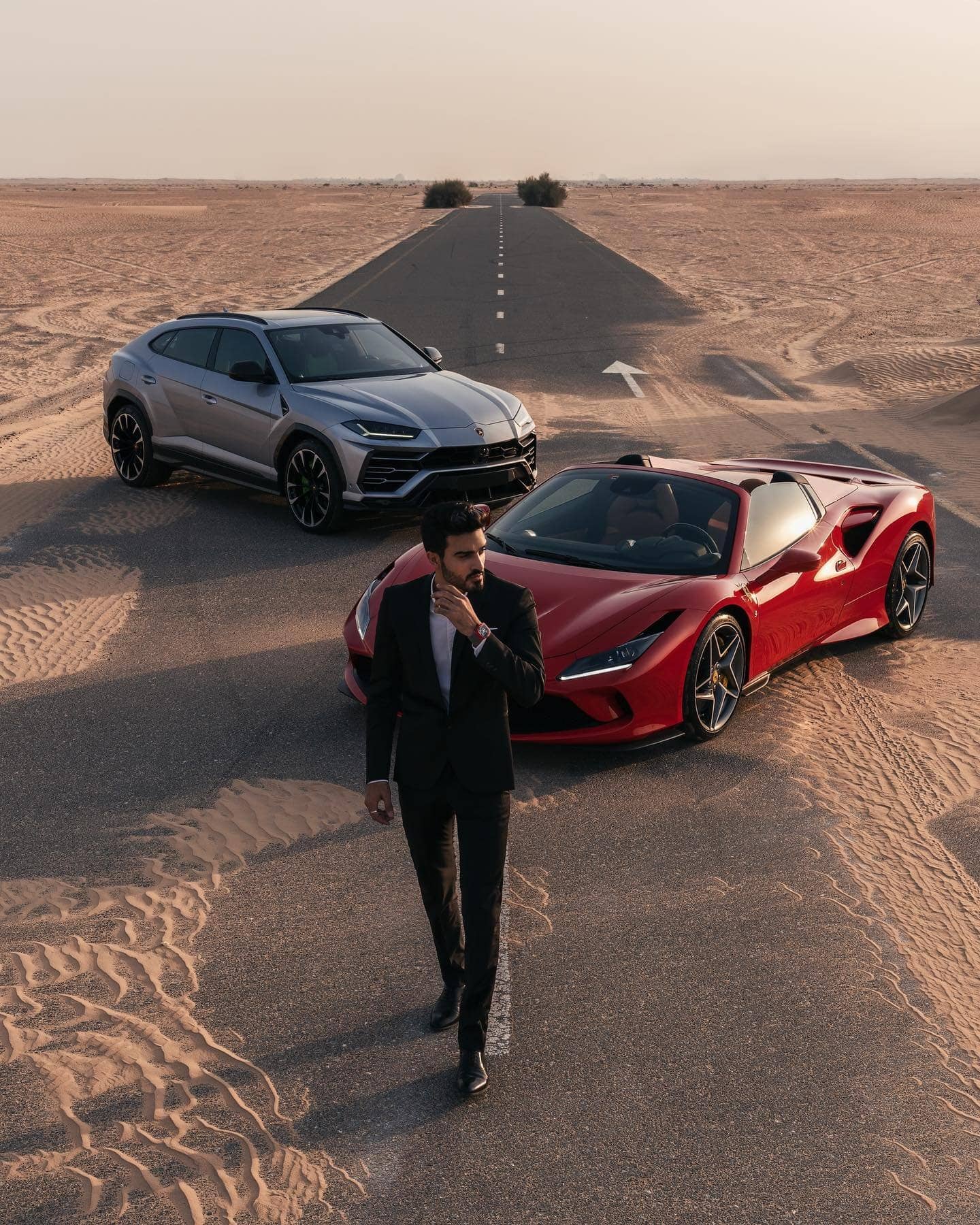 Two supercars and a driver in the desert