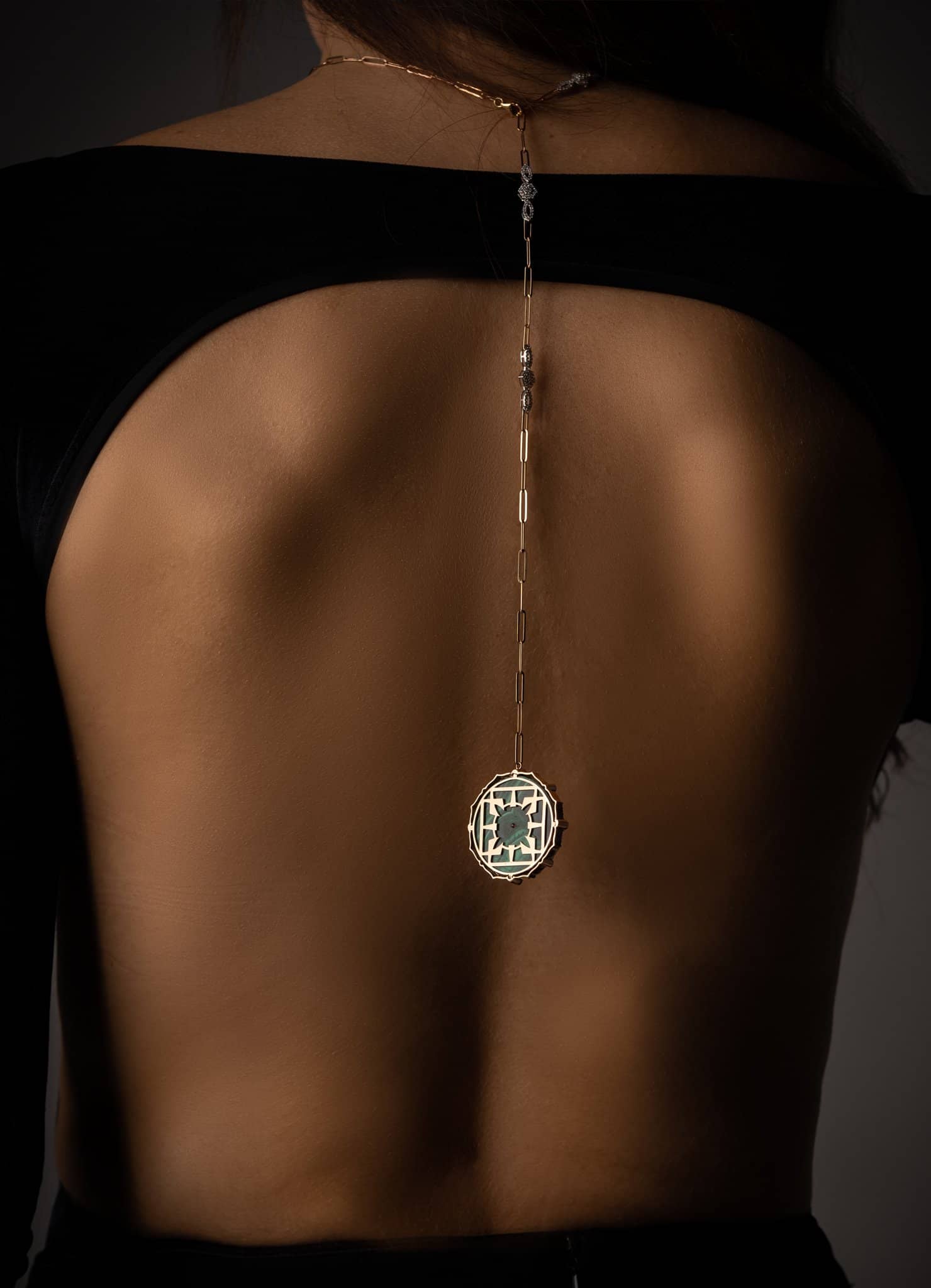 Pendant hanging down a bare back