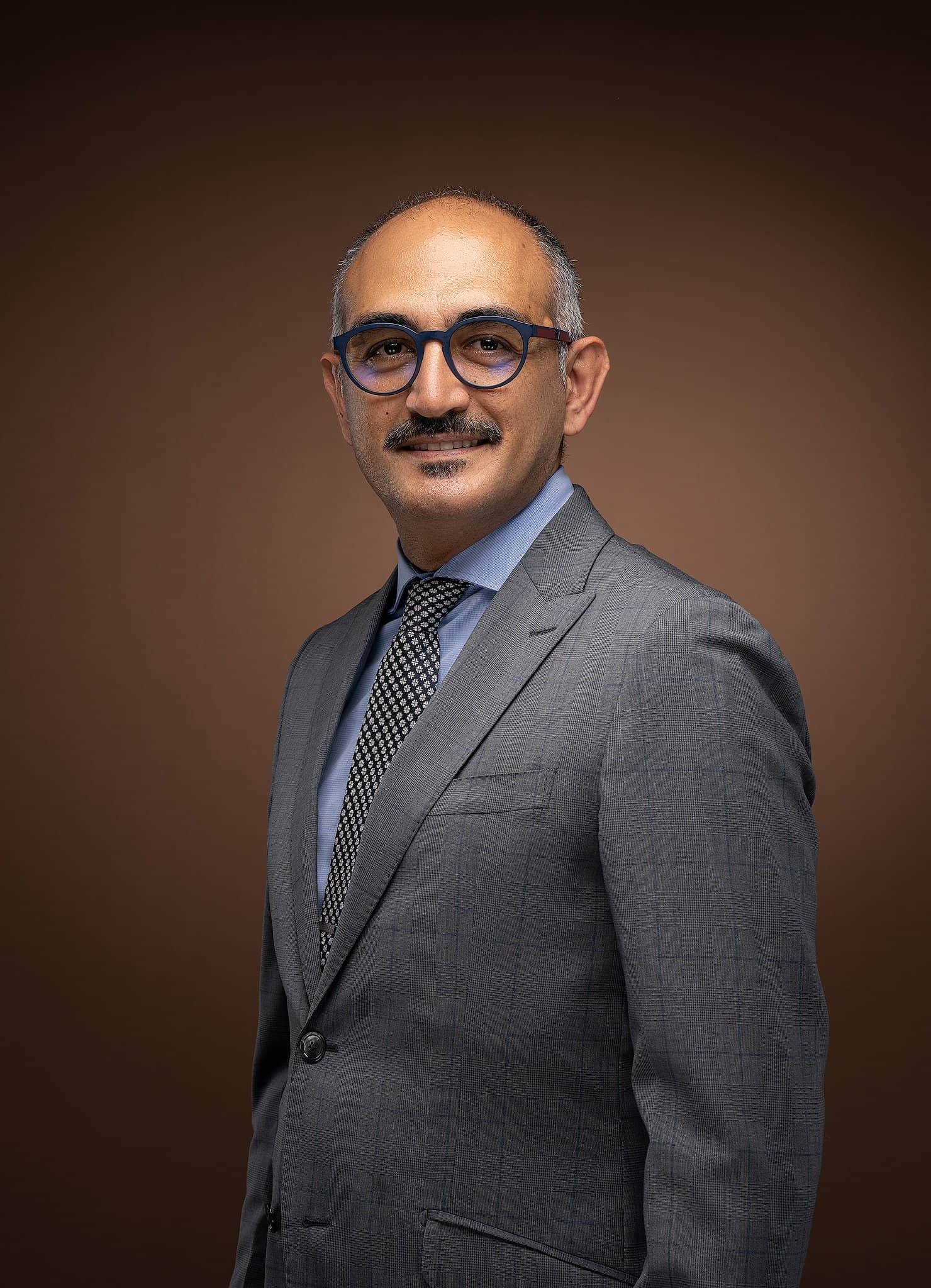 Executive portrait of a man in a grey suit