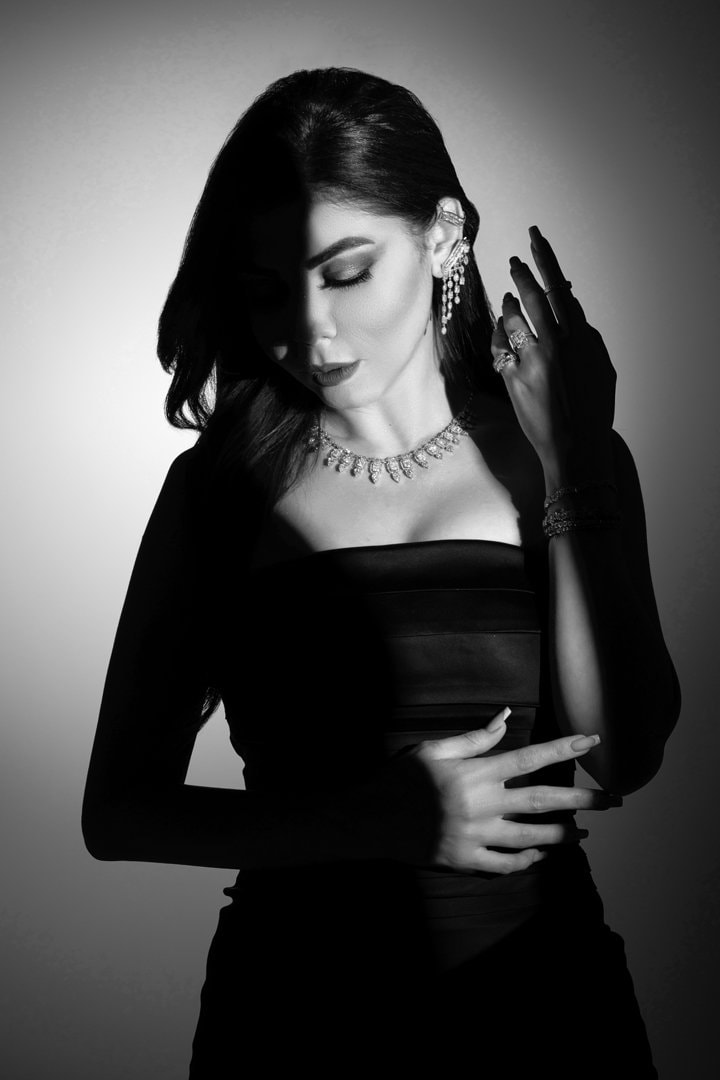 Monochrome portrait of a woman with statement earrings
