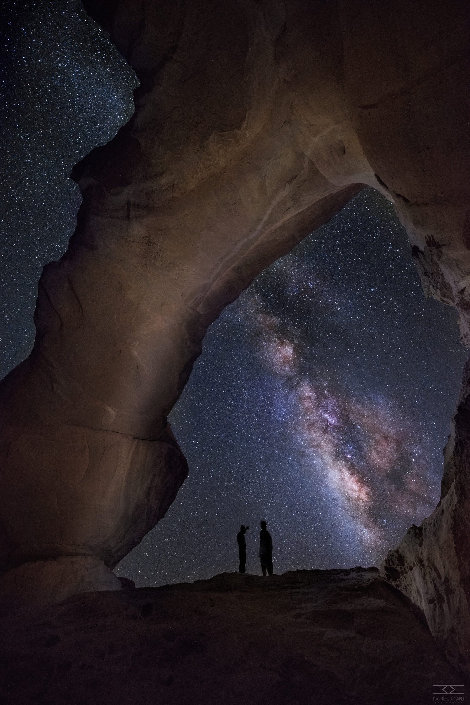 Milky Way arching over a rock bridge in Wadi Rum