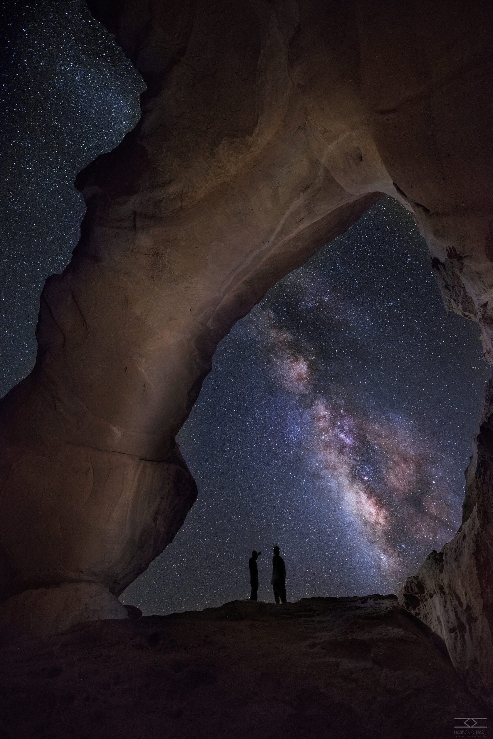 Milky Way arching over a rock bridge in Wadi Rum