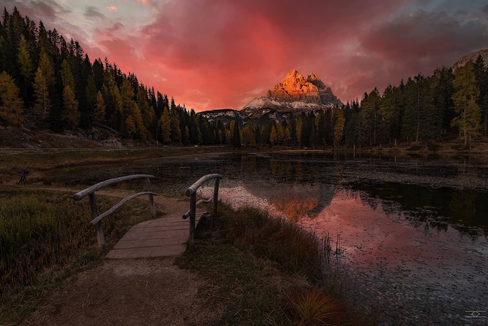 Alpine lake below a glowing peak at sunset
